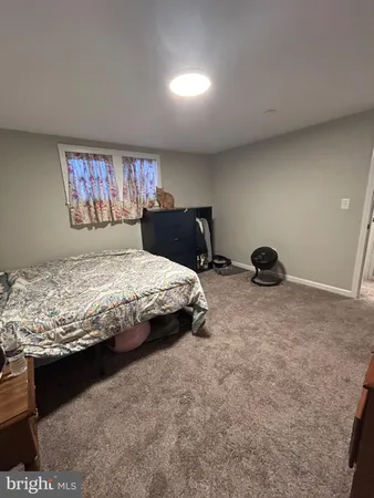 a bedroom with a bed and a view of bedroom