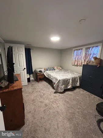 a bedroom with a bed and a television