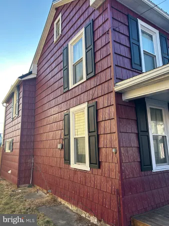 a view of a brick house with a small yard