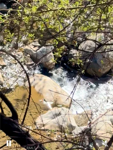 a view of a yard with mountains in the background