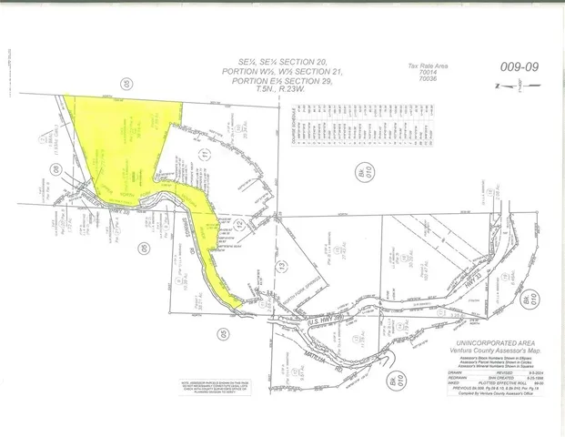 a view of a yard with wooden fence