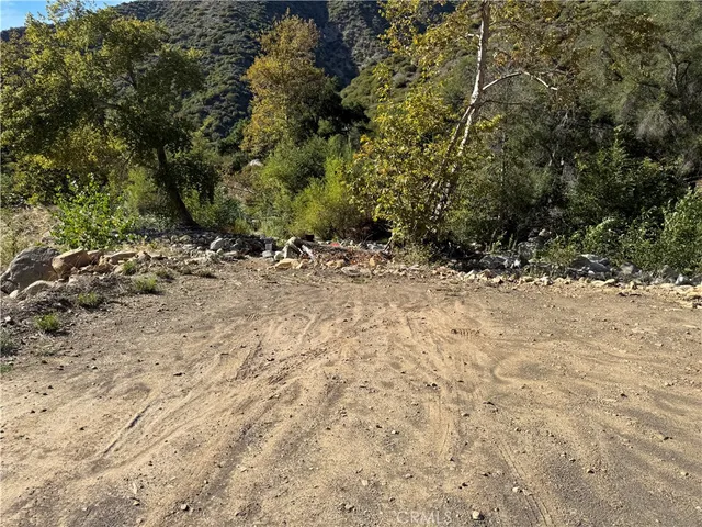 a view of a yard with wooden fence