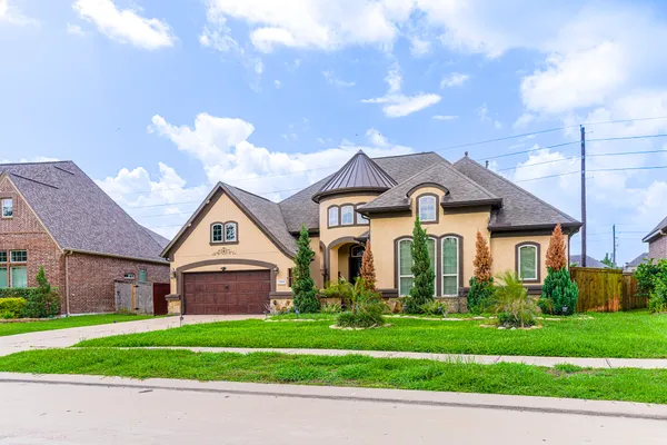 a front view of a house with a yard