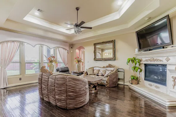 a living room with furniture a flat screen tv and a fireplace