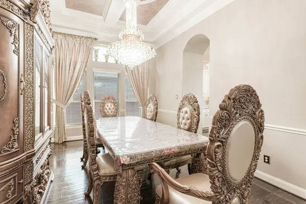 a view of a dining room with furniture and chandelier