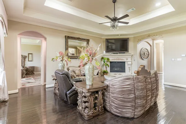 a living room with fireplace furniture and a flat screen tv
