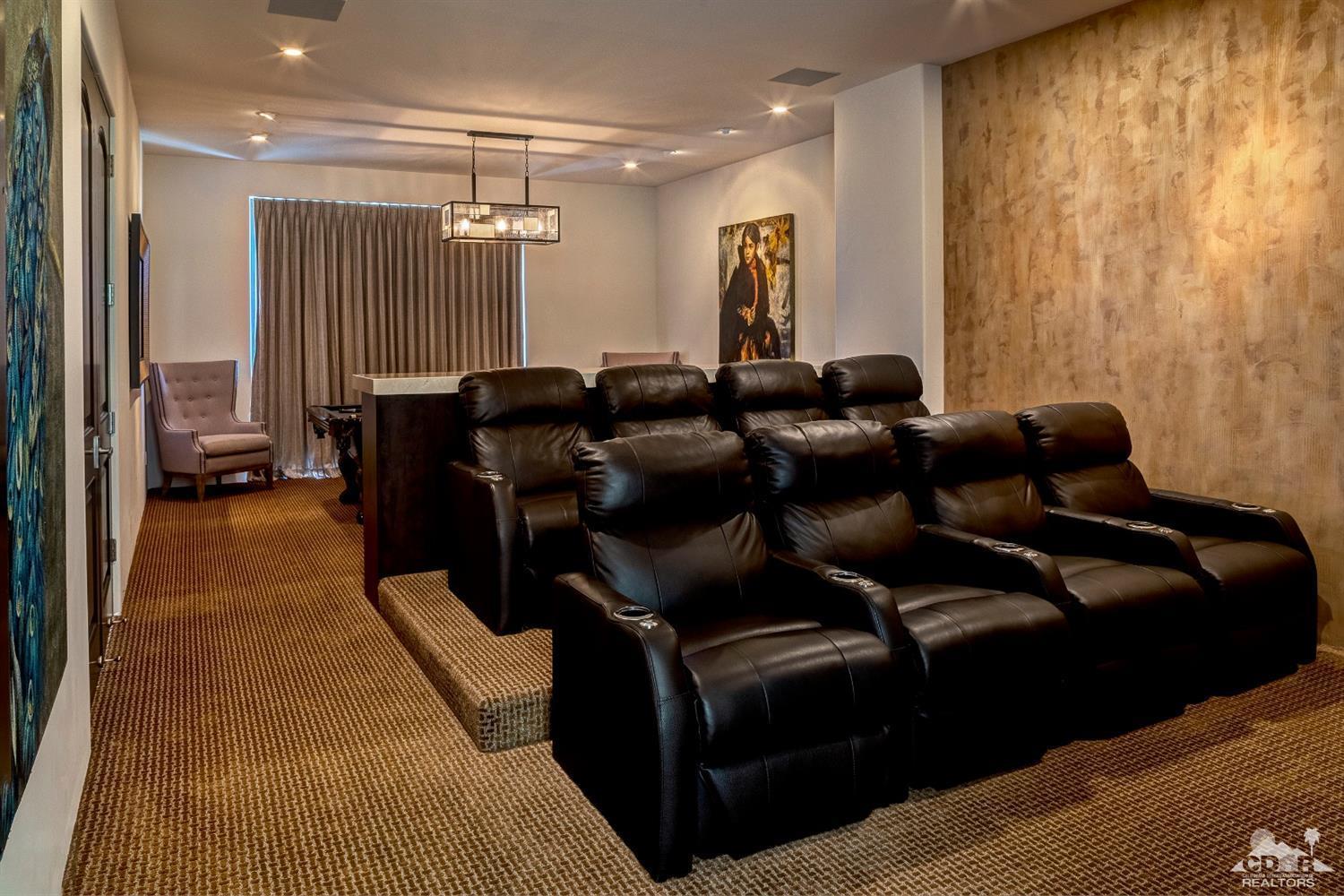 18 Rockcrest Drive Rancho Mirage, CA 92270 - Photo 22 of 35 a media room with lots of chairs and a projector