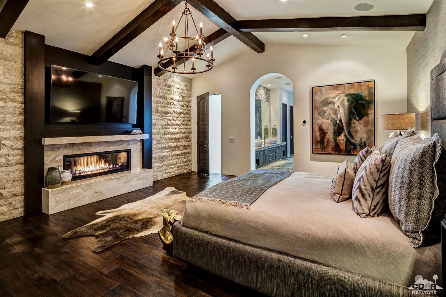 18 Rockcrest Drive Rancho Mirage, CA 92270 - Photo 24 of 35 a bedroom with a bed a flat screen tv and dresser