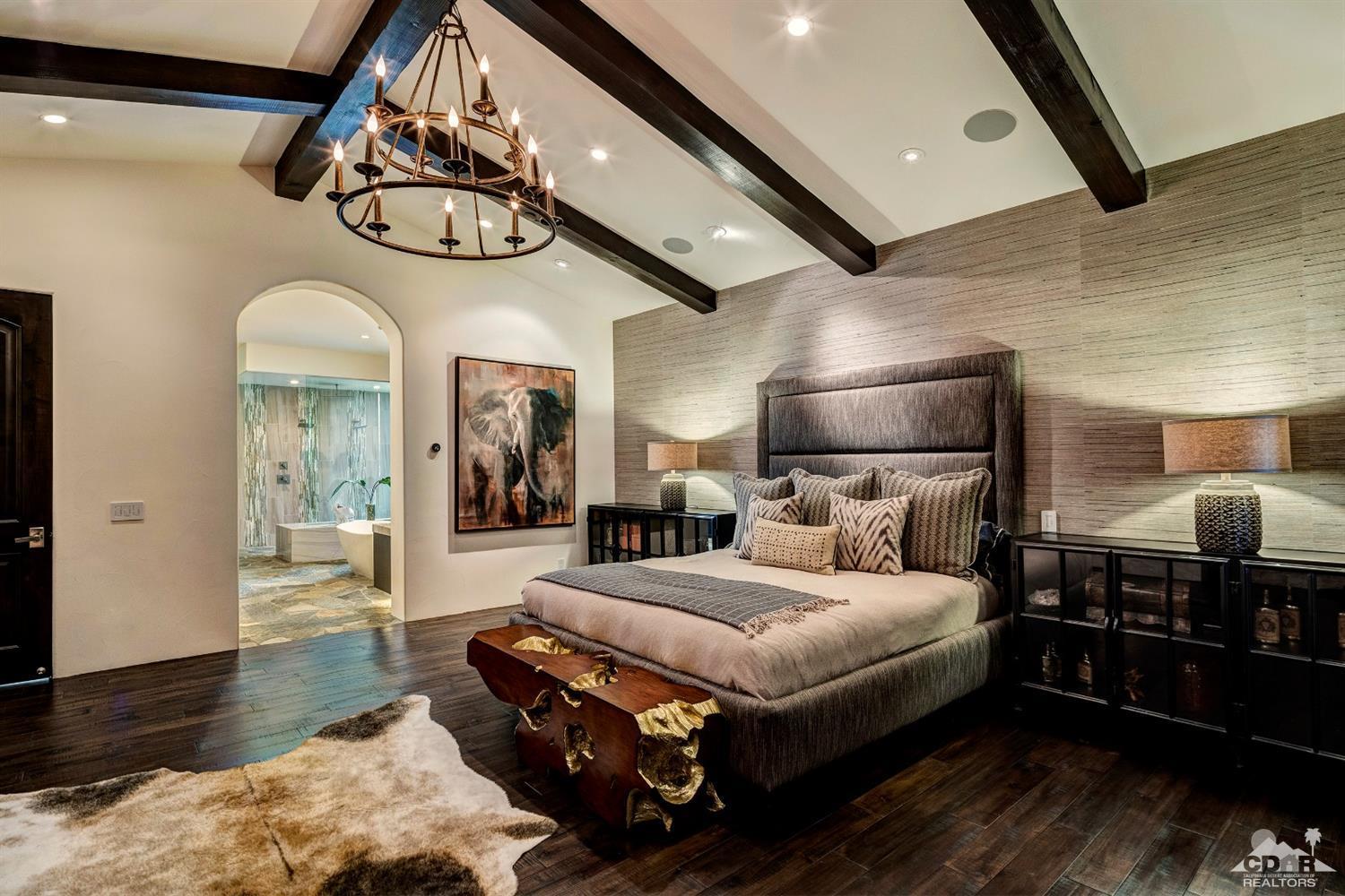 18 Rockcrest Drive Rancho Mirage, CA 92270 - Photo 25 of 35 a bedroom with a bed ceiling fan and a wooden floor