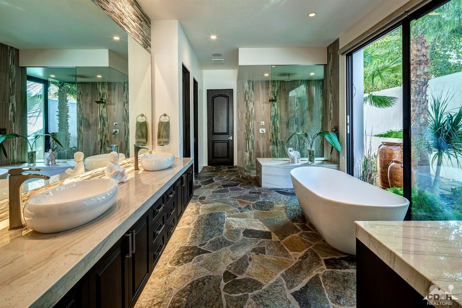18 Rockcrest Drive Rancho Mirage, CA 92270 - Photo 26 of 35 a bathroom with a granite countertop sink and a large mirror