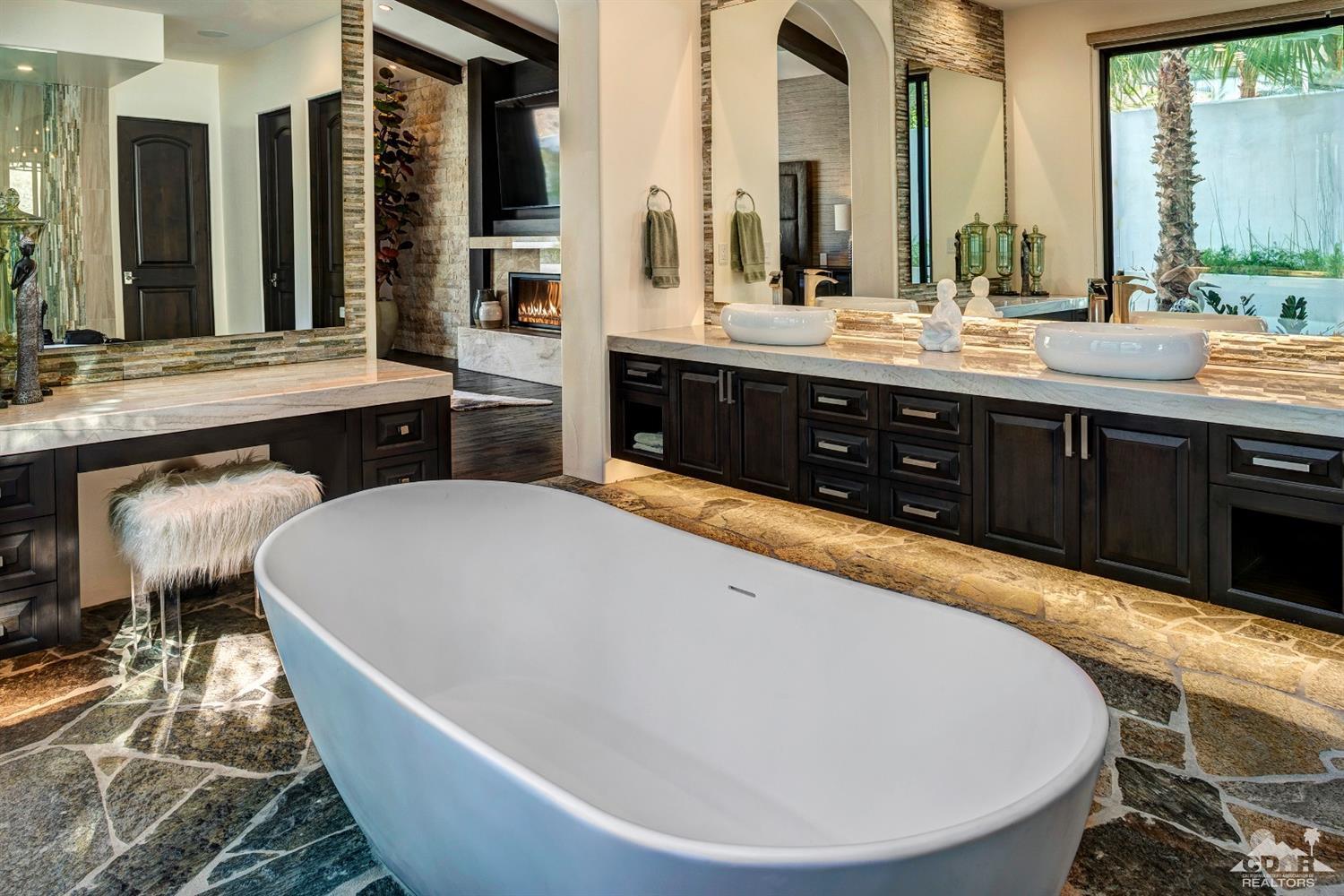 18 Rockcrest Drive Rancho Mirage, CA 92270 - Photo 27 of 35 a large tub sitting next to a bathroom sink and a window