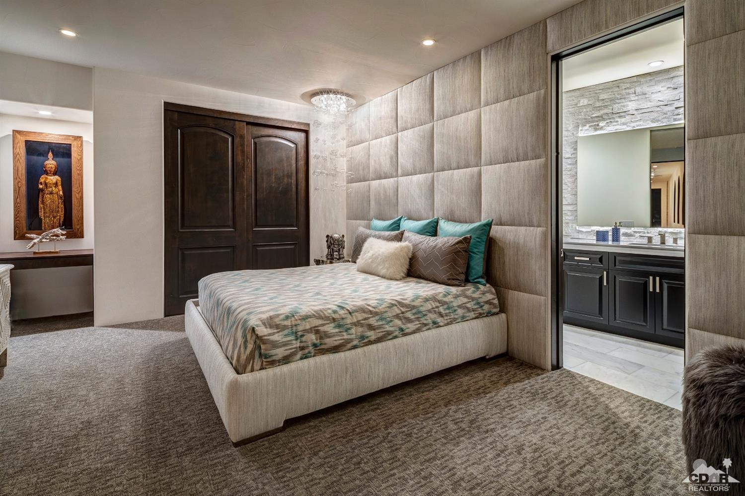 18 Rockcrest Drive Rancho Mirage, CA 92270 - Photo 32 of 35 a bedroom with a bed and a chandelier