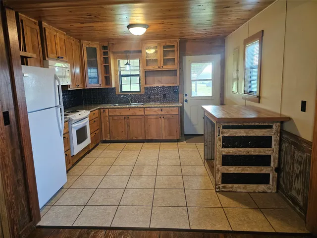 a kitchen with stainless steel appliances a stove a sink and a refrigerator