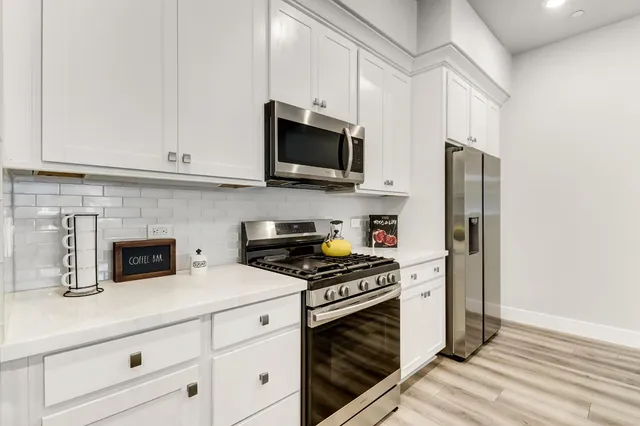 a kitchen with a sink a stove and cabinets