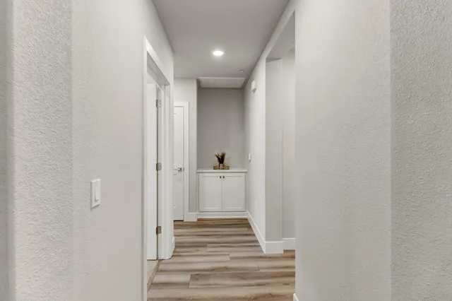 a bedroom with a bed table and a window