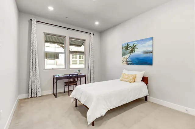 a bedroom with a bed and a table