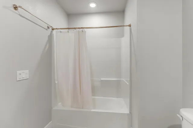 a bathroom with a sink toilet and mirror