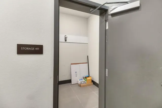 a view of a hallway with windows and closet
