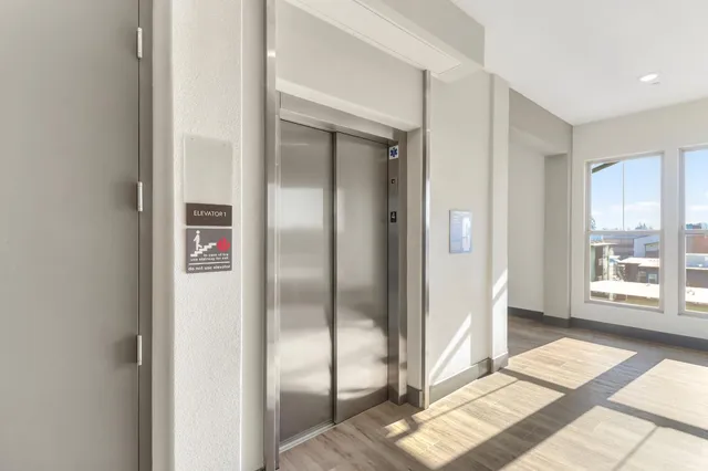 a view of a tall building next to a road