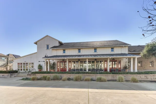 a large white kitchen with lots of counter space furniture and a chandelier