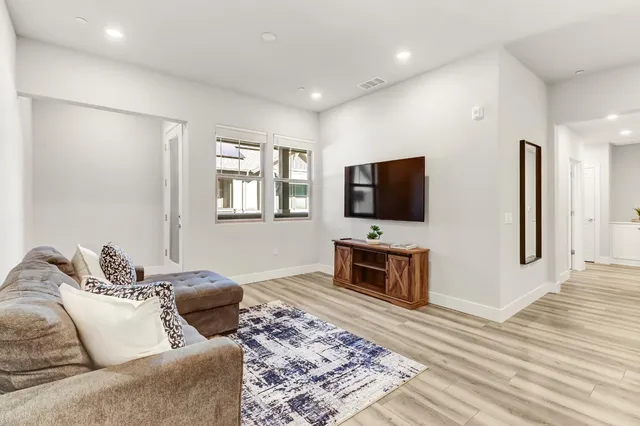a kitchen with a stove and a wooden floor