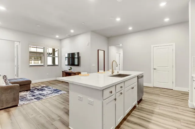 a kitchen with stainless steel appliances granite countertop a sink and stove top oven