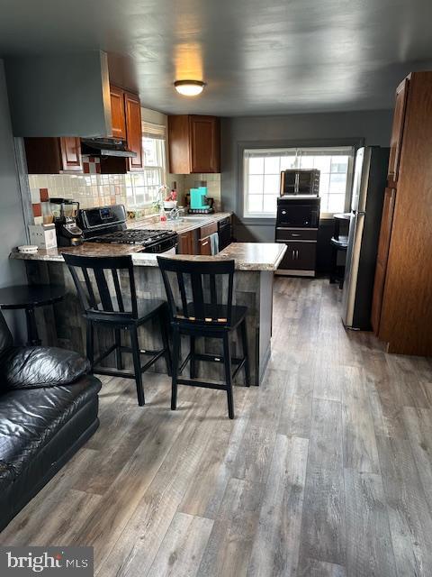 1762 Crown Point Road, Unit 33WS Thorofare, NJ 08086 - Photo 29 of 29 a kitchen with stainless steel appliances kitchen island granite countertop a table chairs sink and cabinets