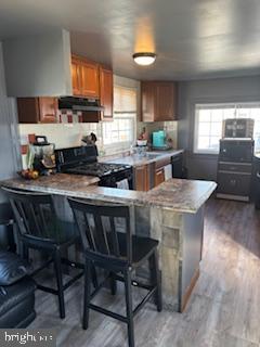 1762 Crown Point Road, Unit 33WS Thorofare, NJ 08086 - Photo 3 of 29 a kitchen with stainless steel appliances granite countertop a stove a sink dishwasher a dining table and chairs with wooden floor