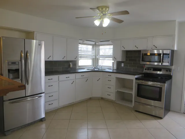 a kitchen with a refrigerator stove and sink