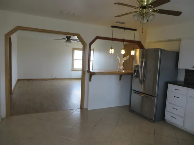 a kitchen with stainless steel appliances a refrigerator and cabinets