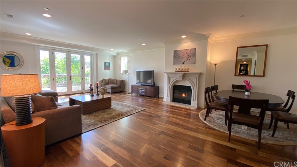 a living room with furniture a large window and a fireplace