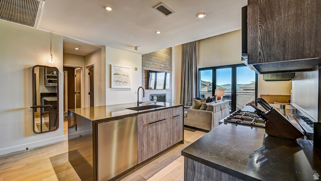 2417 West High Road, Unit 2515 Park City, UT 84098 - Photo 67 of 67 Kitchen with modern cabinets, stainless steel dishwasher, a center island with sink, light wood-type flooring, and open floor plan