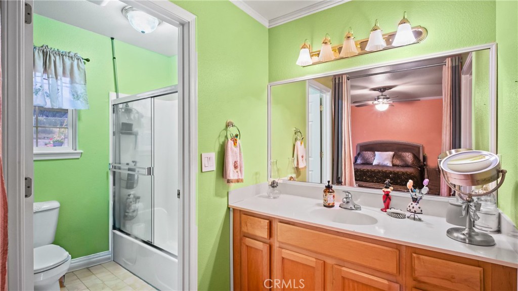 19070 Ravenhill Road Hidden Valley Lake, CA 95467 - Photo 12 of 27 a bathroom with a sink a toilet and a large mirror
