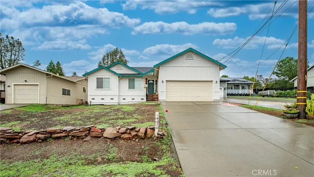 a backyard of a house with table and chairs
