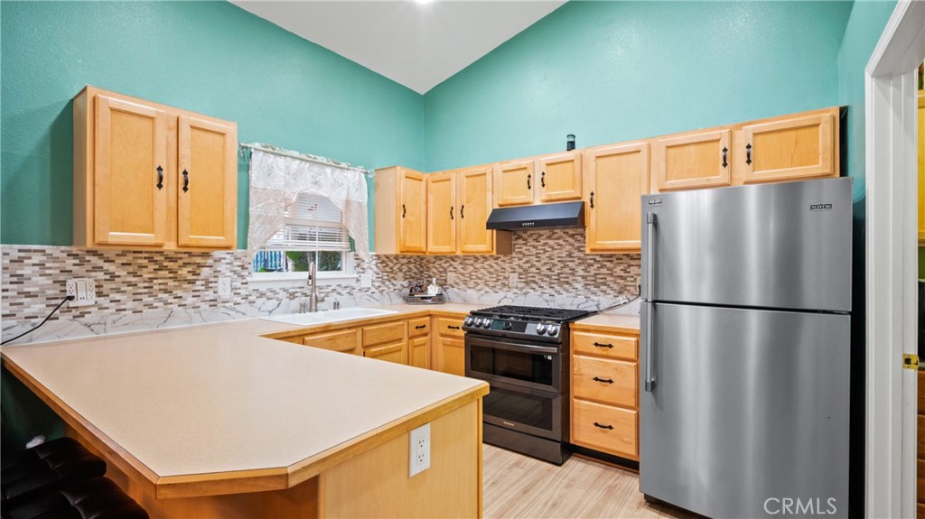 19070 Ravenhill Road Hidden Valley Lake, CA 95467 - Photo 7 of 27 a kitchen with a refrigerator and a sink