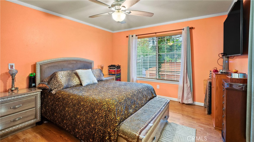 19070 Ravenhill Road Hidden Valley Lake, CA 95467 - Photo 8 of 27 a bed room with a bed and a chandelier
