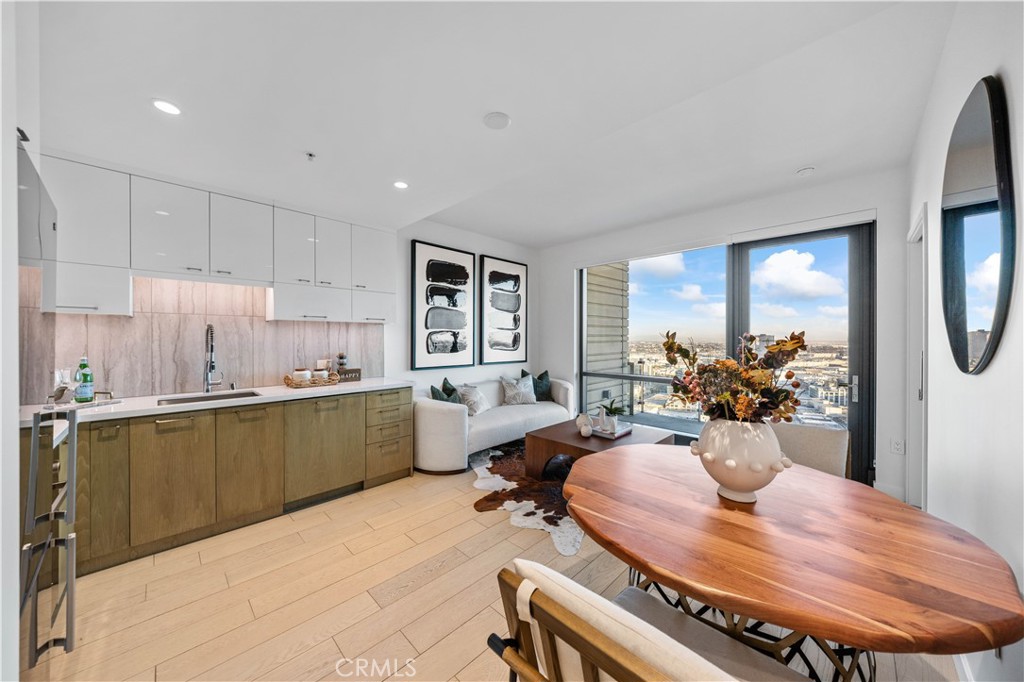 400 South Broadway, Unit 3109 Los Angeles, CA 90013 - Photo 1 of 29 a living room with furniture a chandelier and a dining room