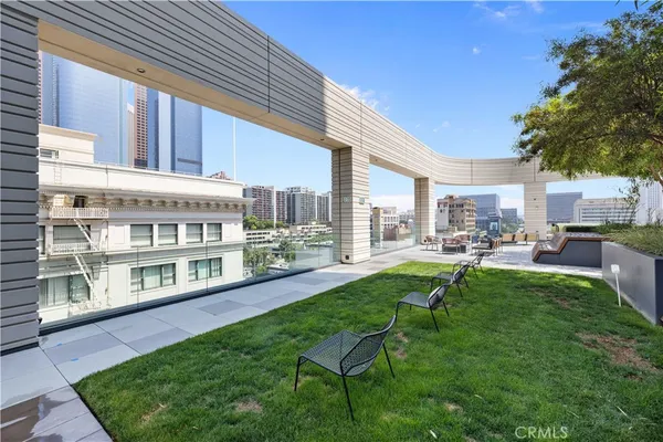a view of a house with backyard porch and sitting area