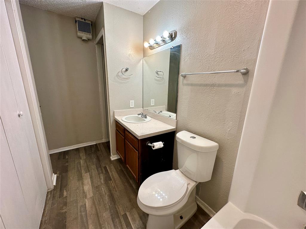 9696 Walnut Street, Unit 617 Dallas, TX 75243 - Photo 11 of 13 a bathroom with a toilet a sink and mirror