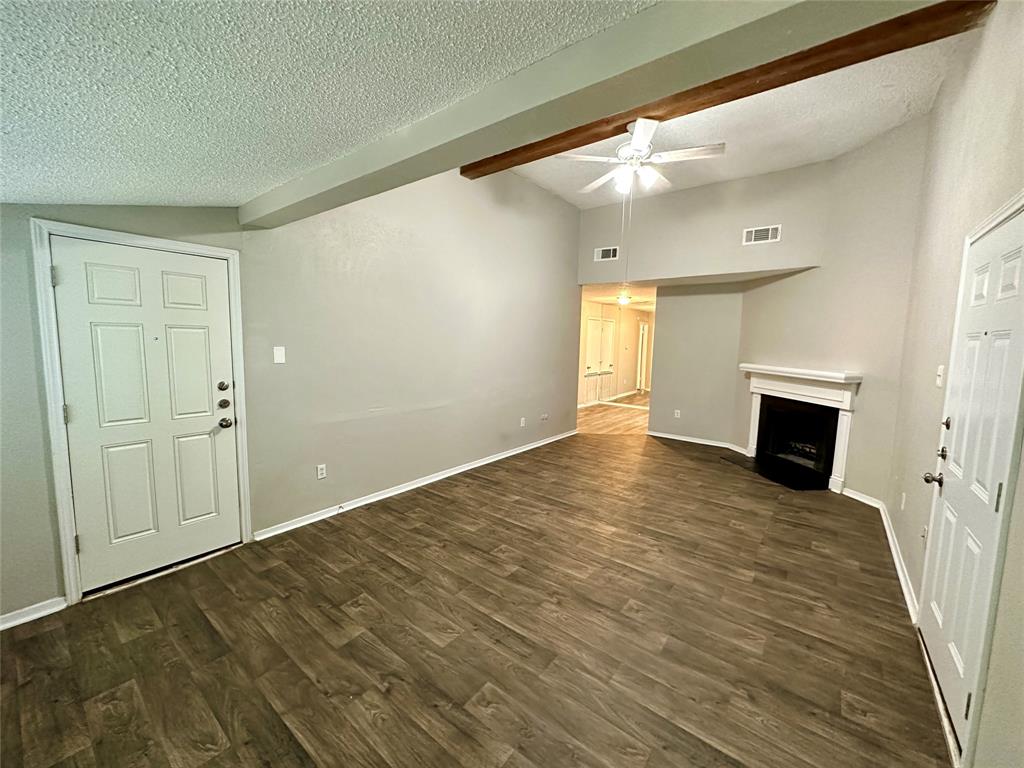 9696 Walnut Street, Unit 617 Dallas, TX 75243 - Photo 3 of 13 a view of empty room with wooden floor and fireplace