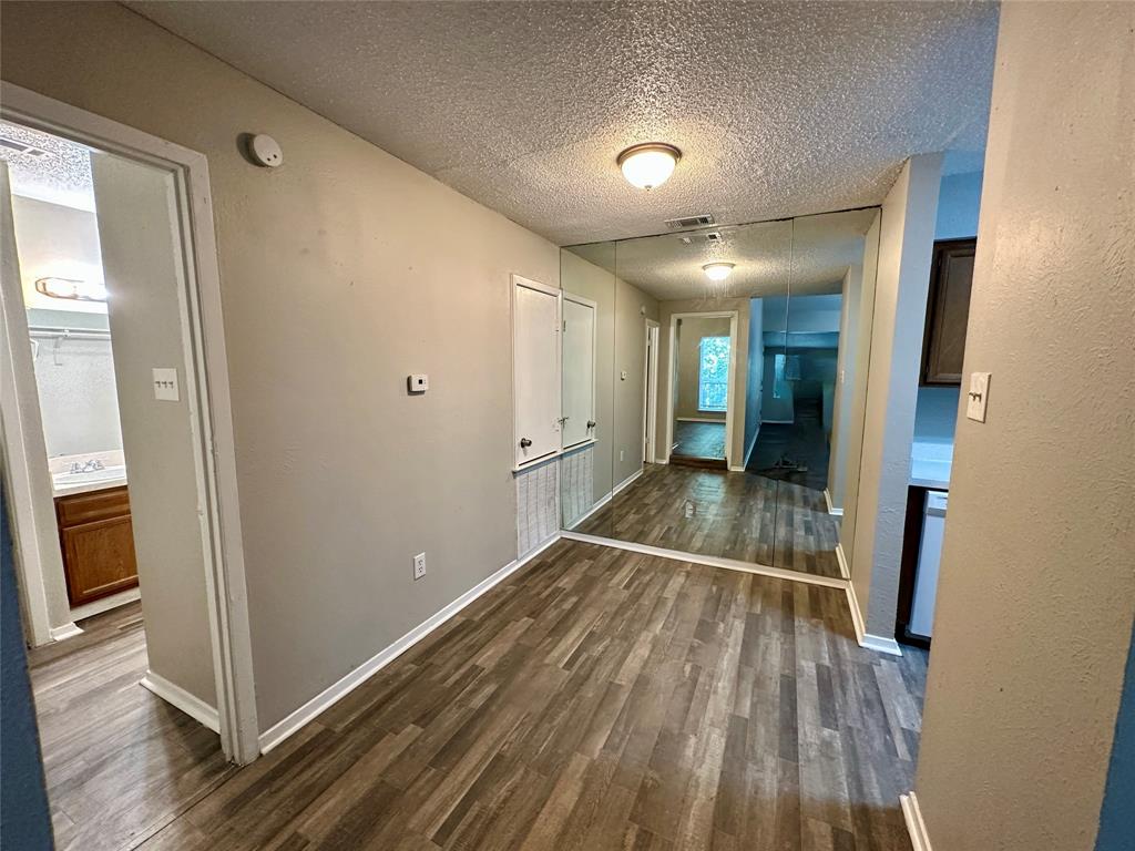 9696 Walnut Street, Unit 617 Dallas, TX 75243 - Photo 4 of 13 a view of a hallway with wooden floor and closet