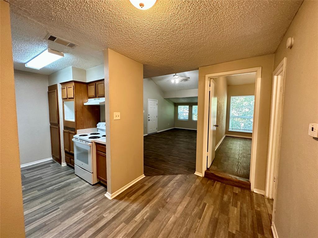 9696 Walnut Street, Unit 617 Dallas, TX 75243 - Photo 5 of 13 a view of a kitchen from the hallway