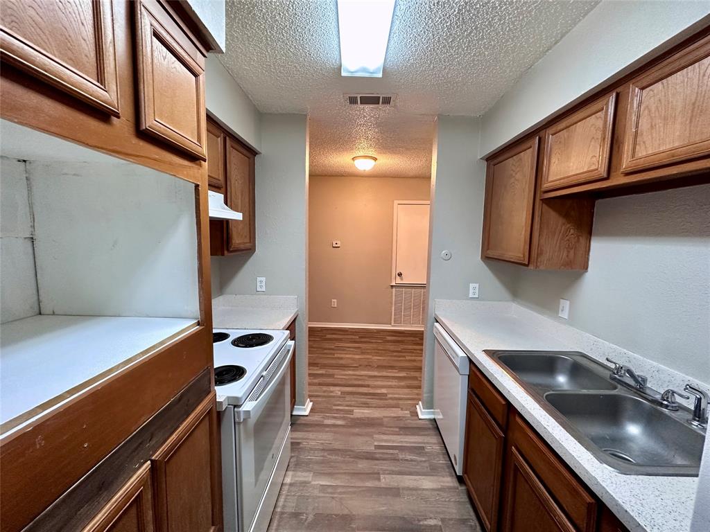 9696 Walnut Street, Unit 617 Dallas, TX 75243 - Photo 7 of 13 a kitchen with a stove and a sink