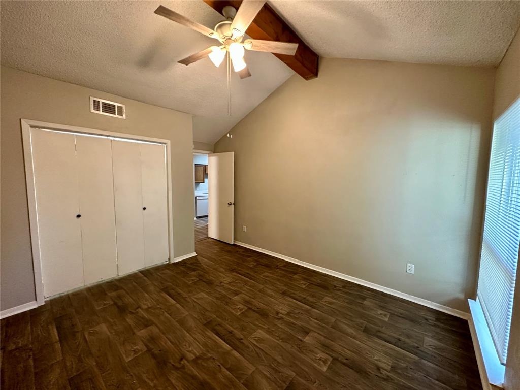 9696 Walnut Street, Unit 617 Dallas, TX 75243 - Photo 8 of 13 an empty room with wooden floor a ceiling fan and closet