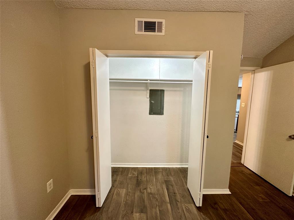 9696 Walnut Street, Unit 617 Dallas, TX 75243 - Photo 9 of 13 a view of front door with wooden floor