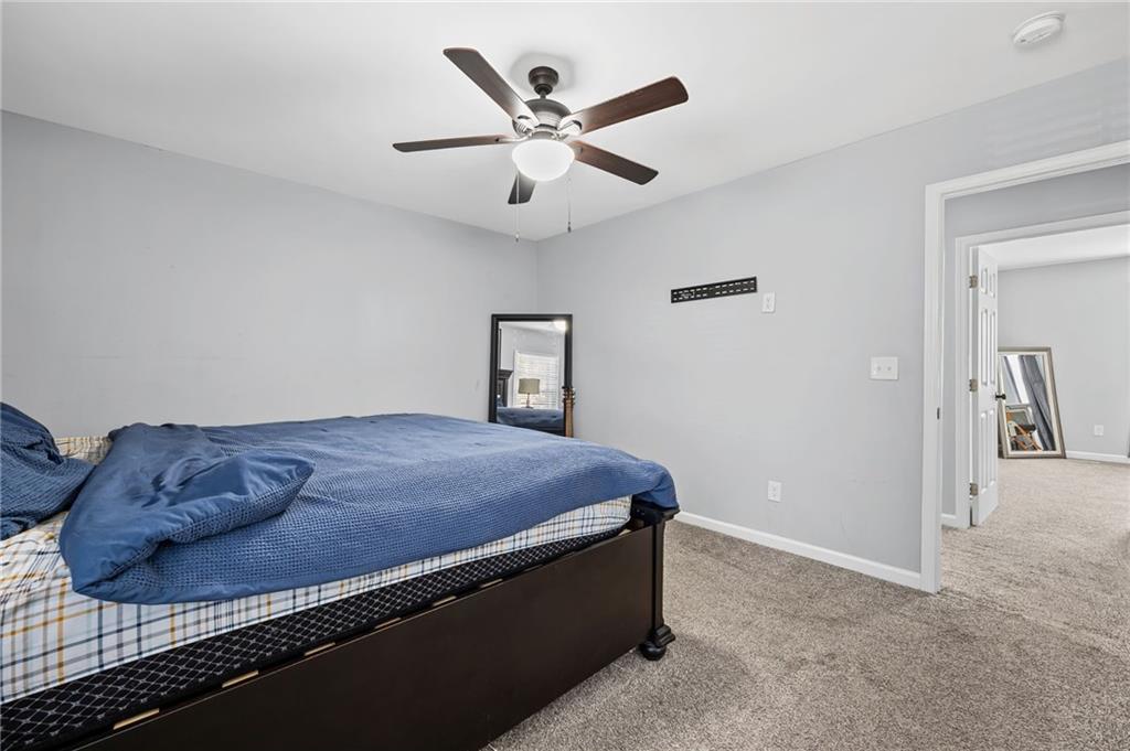 2468 Leslie Brook Drive Decatur, GA 30035 - Photo 24 of 39 a bedroom with a bed and a ceiling fan