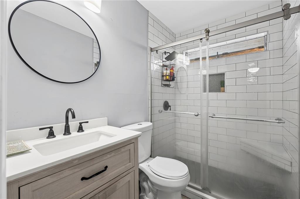 2468 Leslie Brook Drive Decatur, GA 30035 - Photo 26 of 39 a bathroom with a sink mirror toilet and shower