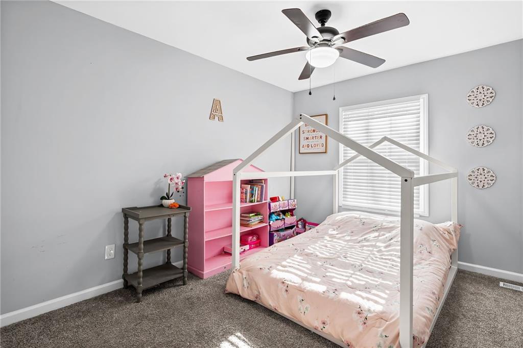 2468 Leslie Brook Drive Decatur, GA 30035 - Photo 27 of 39 a bed room with a bed and a book shelf