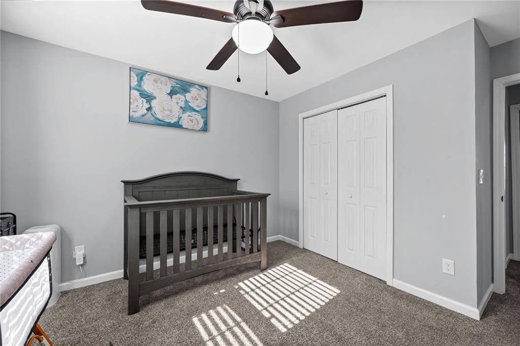 2468 Leslie Brook Drive Decatur, GA 30035 - Photo 30 of 39 a bedroom with a bed and a ceiling fan