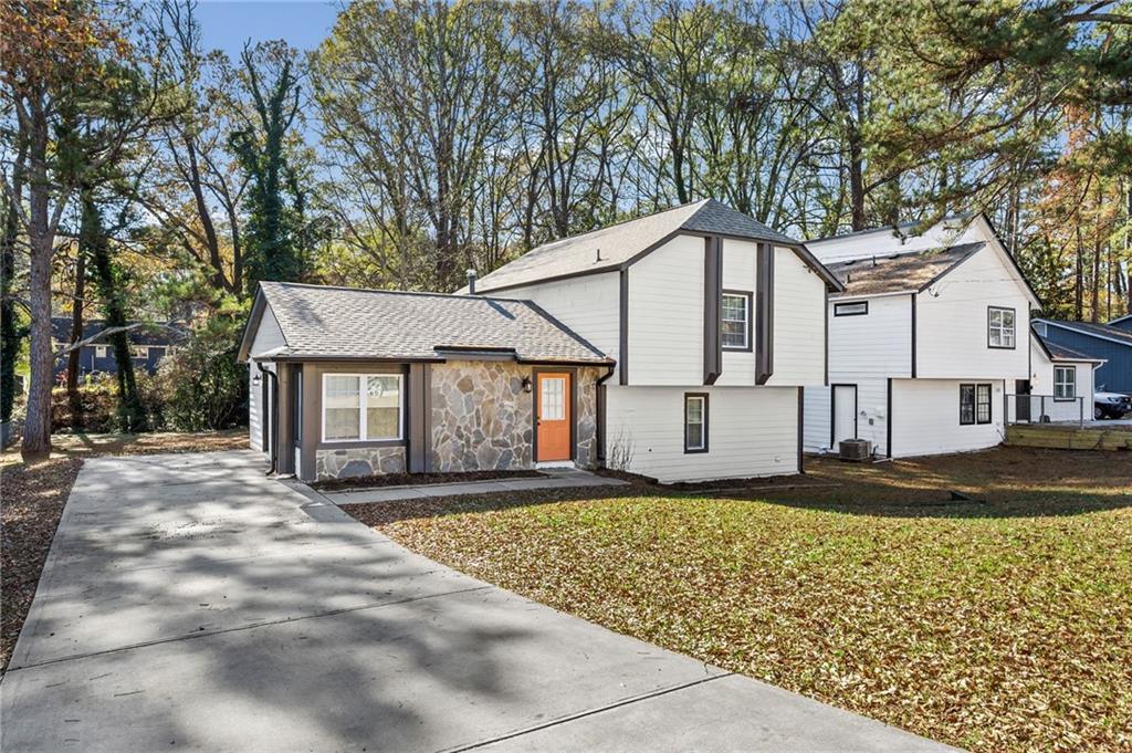 2468 Leslie Brook Drive Decatur, GA 30035 - Photo 5 of 39 a front view of a house with a yard and garage